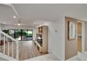Inviting living room with wood-look flooring and sliding glass doors leading to the outdoors at 29909 Baywood Ln, Wesley Chapel, FL 33543