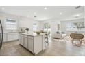 Open-concept kitchen and living area with stainless appliances and lots of natural light at 4275 Big Sky Dr, Spring Hill, FL 34604