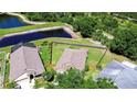 Aerial view of home with large backyard, wooden fence and scenic pond views at 4503 Lace Cascade Ct, Lutz, FL 33558