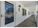 Exterior condo hallway with white stucco walls and unit door number 214 at 4801 Airport Rd # 214, Zephyrhills, FL 33542