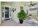 A cozy front porch featuring stylish outdoor furniture and decor, creating a welcoming entrance to the home at 525 Manns Harbor Dr, Apollo Beach, FL 33572
