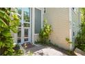 Home exterior with glass block window, neutral siding, and a covered entrance at 6014 Luana S Ln, Gulfport, FL 33707