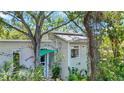 Charming home exterior with lush landscaping, colorful accents, and a cozy, inviting facade at 6014 Luana S Ln, Gulfport, FL 33707
