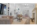 Bright open-plan living room boasts vaulted ceilings, modern furnishings, and seamless flow into the kitchen and dining areas at 6014 Luana S Ln, Gulfport, FL 33707