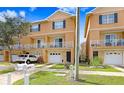 Charming townhouse showcasing a white balcony, neatly kept front lawn and convenient garage parking at 6823 S Kissimmee St, Tampa, FL 33616