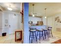 Kitchen bar with seating, stainless appliances, white cabinets, and modern track lighting at 7903 Seminole Blvd # 2103, Seminole, FL 33772