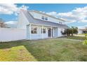 Charming two-story home shows off its metal roof, and a well-manicured lawn and landscaping at 8439 Boxwood Dr, Tampa, FL 33615