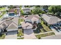 Expansive aerial view of a two-story home featuring a paved driveway and a manicured lawn in a residential neighborhood at 10003 Vista Pointe Dr, Tampa, FL 33635
