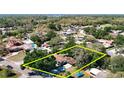 An aerial view of a single story home on a lot surrounded by mature trees at 13116 N Oregon Ave, Tampa, FL 33612