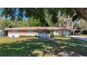 Quaint single-story house with red brick accents, well-maintained lawn, and a cozy, inviting entrance at 13116 N Oregon Ave, Tampa, FL 33612