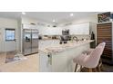 Bright kitchen features white cabinets, stainless steel appliances, and granite countertops at 1410 25Th N St, St Petersburg, FL 33713