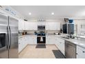 Well-equipped kitchen with stainless steel appliances and ample white cabinetry for storage at 1410 25Th N St, St Petersburg, FL 33713