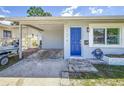 Charming home featuring a bright blue front door and an open carport at 1734 Shore Acres Ne Blvd, St Petersburg, FL 33703