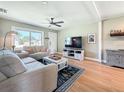 Comfortable living room featuring wood floors, a ceiling fan, and a large window at 1734 Shore Acres Ne Blvd, St Petersburg, FL 33703