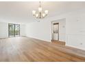 Bright living room with wood floors, large window, modern light fixture, and washer/dryer hookups at 201 Laurel # 308, Tampa, FL 33602
