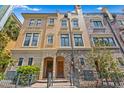 Attractive townhome with tan and stone accents, wrought iron fence, and brick walkway at 2226 Soho Bay Ct, Tampa, FL 33606