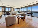 Bright living room with hardwood floors and expansive windows offering stunning water views at 3301 Bayshore Blvd # 2003D, Tampa, FL 33629
