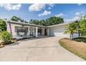Charming single-story home with a brick facade, gray shutters and a spacious driveway at 3631 Coppertree Cir, Brandon, FL 33511