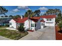 Charming two-story home with a red tile roof, white exterior, and a well-manicured front yard at 4151 Sunrise S Dr, St Petersburg, FL 33705