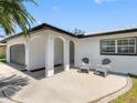 Covered front porch with seating area, offering a cozy entrance to the home at 5731 Denver Ne St, St Petersburg, FL 33703