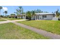 Street view showcasing a well-maintained lawn, driveway, and the home's exterior at 5731 Denver Ne St, St Petersburg, FL 33703
