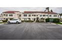Exterior view of condo buildings showcasing well-maintained landscaping and ample parking at 6077 Bahia Del Mar Blvd # 123, St Petersburg, FL 33715