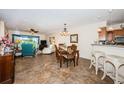 Open-concept living space featuring tile floors and an outdoor view of the golf course at 6077 Bahia Del Mar Blvd # 123, St Petersburg, FL 33715