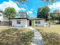 Inviting single-story home with a fresh exterior and a well-cared for front yard at 7101 N 9Th St, Tampa, FL 33604