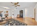 Comfortable living area featuring hardwood floors and an open layout to the dining area at 7234 Riverwood Blvd, Tampa, FL 33615