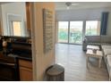 Bright living room with ocean view balcony access, and coastal decor at 880 Mandalay Ave # C704, Clearwater Beach, FL 33767