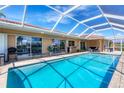 Inviting screened-in pool area with comfortable seating, offering a perfect outdoor retreat with plenty of sunshine at 890 Coronado Dr, Punta Gorda, FL 33950