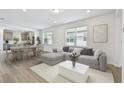 Bright living room flows into the dining area and features light-colored wood floors at 9535 Coastline Way, Parrish, FL 34219