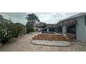 Backyard pool featuring tiki-style shade coverings over an outdoor living space at 997 Boca Ciega Isle Dr, St Pete Beach, FL 33706