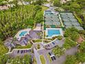 Aerial view of the community clubhouse, pool, tennis courts and ample parking spaces at 10130 Deercliff Dr, Tampa, FL 33647