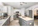 An updated kitchen features granite countertops, stainless steel appliances and ample cabinet space at 10308 Boyette Creek Blvd, Riverview, FL 33569