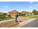Well-maintained single-story home with a decorative driveway and lush landscaping at 17425 Eagle Trace Dr, Brooksville, FL 34604