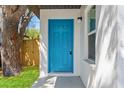 Close-up of the beautiful, bright blue front door and surrounding textured stucco wall at 1843 38Th S St, St Petersburg, FL 33711