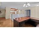 Spacious layout with wood floors, glass block feature, and view into kitchen area at 2023 Golfview Dr # 2023, Tarpon Springs, FL 34689