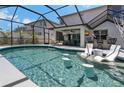 Resort-style pool with built-in bar stools and lounge chairs under a screened enclosure at 2109 N Jamaica St, Tampa, FL 33607