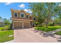 Charming two-story home with a well-maintained lawn, double garage, and a beautiful terracotta tile roof at 2671 Lakebreeze S Ln, Clearwater, FL 33759