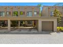Contemporary townhome exterior featuring a private carport, garage, gray brick drive and modern architectural details at 4118 Gauge Line Loop, Tampa, FL 33624
