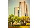 A beautiful exterior view of the condo building surrounded by lush green trees at 4141 Bayshore Blvd # 1103, Tampa, FL 33611
