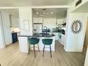 Bright kitchen featuring modern lighting, white cabinets, and a black countertop island with seating at 4141 Bayshore Blvd # 1103, Tampa, FL 33611