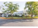 A corner lot featuring an eye-catching metal roof, carport, and mature trees at 4235 Tamargo Dr # 4235, New Port Richey, FL 34652