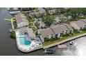 A high angle view showcases waterfront condos with a community pool and available boat docks at 428 Moorings Cove Dr # 7F, Tarpon Springs, FL 34689