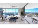 Bright, modern living room with floor-to-ceiling windows and a spacious balcony overlooking the city and water at 520 N Tampa St # 1508, Tampa, FL 33602