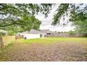 Large, private backyard featuring a wooden fence and ample space for recreation and entertaining at 538 Summer Sails Dr, Valrico, FL 33594