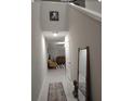 Bright hallway with tall ceiling, decorative mirror and decor at 5511 Rainwood Meadows Dr, Apollo Beach, FL 33572