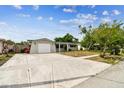 Lovely single-story home featuring a spacious driveway, lush landscaping and one-car garage at 5810 8Th Ave, New Port Richey, FL 34652