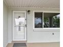 Close-up of the front door, showcasing the entryway and nearby window at 5810 8Th Ave, New Port Richey, FL 34652